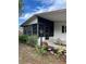 Charming screened-in porch with mature landscaping providing curb appeal to the home at 222 Palmer Park Ln, Davenport, FL 33897