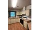Well-maintained kitchen featuring laminate floors, a vintage oven, and neutral-toned cabinets for a classic feel at 222 Palmer Park Ln, Davenport, FL 33897