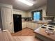 Functional kitchen with wood cabinets, matching countertops, and modern black appliances at 222 Palmer Park Ln, Davenport, FL 33897