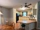 Kitchen featuring laminate floors, breakfast bar, view to dining room and black appliances at 222 Palmer Park Ln, Davenport, FL 33897