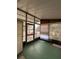 Sunroom with green carpet, large windows, and vertical blinds at 222 Palmer Park Ln, Davenport, FL 33897