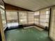 Sunroom with green carpet, large windows, and vertical blinds at 222 Palmer Park Ln, Davenport, FL 33897