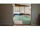 Sun room features vinyl flooring and many windows with vertical blinds for bright natural light at 222 Palmer Park Ln, Davenport, FL 33897