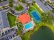Community aerial view featuring a pool, playground, tennis court, buildings, and a beautiful pond at 2794 Club Cortile Cir # B, Kissimmee, FL 34746