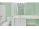 Bright bathroom featuring a large mirror, ample vanity space, and modern fixtures at 2794 Club Cortile Cir # B, Kissimmee, FL 34746