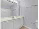Well-lit bathroom featuring a large mirror, vanity with cabinet, and tile flooring at 2794 Club Cortile Cir # B, Kissimmee, FL 34746