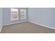 Bedroom with neutral carpet, two windows, and light blue walls at 2794 Club Cortile Cir # B, Kissimmee, FL 34746