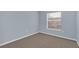 Cozy bedroom features soft carpet, light blue walls, and a window at 2794 Club Cortile Cir # B, Kissimmee, FL 34746