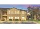 Low angle showing a two-story condo building featuring decorative landscaping and exterior stairwells at 2794 Club Cortile Cir # B, Kissimmee, FL 34746