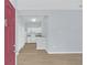 Welcoming entryway featuring wood-look flooring, a view of the kitchen, and abundant natural light at 2794 Club Cortile Cir # B, Kissimmee, FL 34746