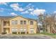Inviting two-story condo building featuring neutral colors, well-maintained landscaping, and a charming, bright exterior at 2794 Club Cortile Cir # B, Kissimmee, FL 34746