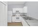 Well-lit kitchen featuring white cabinets, stainless steel appliances, and ample countertop space at 2794 Club Cortile Cir # B, Kissimmee, FL 34746