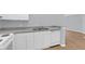 Modern kitchen with white cabinets, a stainless steel sink, and essential appliances at 2794 Club Cortile Cir # B, Kissimmee, FL 34746