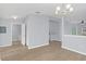 Open living area with wood floors, modern light fixture, and easy access to bathroom and kitchen at 2794 Club Cortile Cir # B, Kissimmee, FL 34746