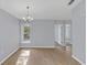 Open living space featuring modern light fixture, neutral wall paint, and attractive wood-look floors at 2794 Club Cortile Cir # B, Kissimmee, FL 34746
