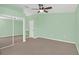 Spacious main bedroom featuring a ceiling fan, plush carpeting, and a walk-in closet at 2794 Club Cortile Cir # B, Kissimmee, FL 34746
