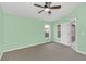 Bright main bedroom with a ceiling fan, plush carpeting, and large windows at 2794 Club Cortile Cir # B, Kissimmee, FL 34746