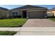 Charming single-story home with a brick paver driveway and well-maintained lawn at 2802 Glendive Dr, Kissimmee, FL 34758