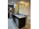 Kitchen with stainless steel refrigerator, gray granite countertop island and sink with a stainless steel dishwasher at 2802 Glendive Dr, Kissimmee, FL 34758