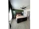 Bright main bedroom boasts an accent wall, ceiling fan, and luxury vinyl plank flooring at 2802 Glendive Dr, Kissimmee, FL 34758