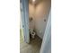 Compact toilet room features a toilet, toilet paper dispenser and mounted shelf, all in pristine white at 2802 Glendive Dr, Kissimmee, FL 34758