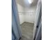 Walk-in closet with metal shelving and wood-look tile flooring providing ample storage space at 2802 Glendive Dr, Kissimmee, FL 34758