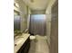 Clean bathroom with a single sink vanity, tile flooring, and shower-tub combo at 3100 Rocky River Rd, Kissimmee, FL 34746