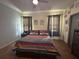 Bright bedroom with natural light, decorative art, and wood-look floors at 3100 Rocky River Rd, Kissimmee, FL 34746