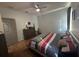 Comfortable bedroom featuring a ceiling fan, dresser, and wood-look flooring at 3100 Rocky River Rd, Kissimmee, FL 34746