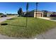 Spacious front yard with green grass, showcasing the detached garage and neighboring homes at 3100 Rocky River Rd, Kissimmee, FL 34746