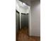 Hallway featuring wood-look tile floors and multiple doors at 3100 Rocky River Rd, Kissimmee, FL 34746