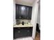 Butler pantry features elegant cabinets, granite counters, and beverage appliances at 3100 Rocky River Rd, Kissimmee, FL 34746