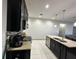 Kitchen view with tile floors, granite countertops, and stainless steel dishwasher at 3100 Rocky River Rd, Kissimmee, FL 34746
