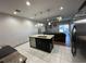 Kitchen island offers a breakfast bar and sink, opening to living area at 3100 Rocky River Rd, Kissimmee, FL 34746