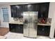 Kitchen boasts granite countertops, stainless steel appliances, and black cabinets at 3100 Rocky River Rd, Kissimmee, FL 34746