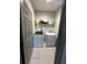 Modern laundry room equipped with a washer, dryer, and practical shelving at 3100 Rocky River Rd, Kissimmee, FL 34746