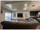Cozy living room featuring a large sectional sofa, wood-look floors, and a mounted television for entertainment at 3100 Rocky River Rd, Kissimmee, FL 34746
