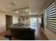 Spacious living room features modern decor, tv and sliding glass door at 3100 Rocky River Rd, Kissimmee, FL 34746