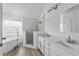 Bright bathroom showcasing a tub, tiled shower, double vanity, and modern finishes at 3193 Verbena Ct, Deltona, FL 32725