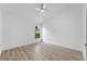 Bright bedroom with wood floors, a ceiling fan, and a window view of greenery at 3193 Verbena Ct, Deltona, FL 32725