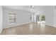 Bright bedroom with wood floors, two windows, and a sliding glass door at 3193 Verbena Ct, Deltona, FL 32725