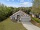Inviting one-story home with attached garage, pristine lawn and neutral color palette at 3193 Verbena Ct, Deltona, FL 32725
