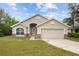 Charming single-story home featuring a two-car garage and well-maintained lawn at 3193 Verbena Ct, Deltona, FL 32725