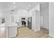 Open-concept kitchen featuring white cabinets and stainless steel appliances at 3193 Verbena Ct, Deltona, FL 32725