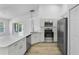 Bright kitchen featuring stainless steel appliances, ample counter space, and light wood flooring at 3193 Verbena Ct, Deltona, FL 32725