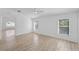 Spacious living room with natural light, wood flooring, and open layout to a dining area at 3193 Verbena Ct, Deltona, FL 32725