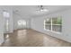 Bright living room with sleek ceiling fan and large windows at 3193 Verbena Ct, Deltona, FL 32725