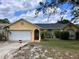 Charming one-story home featuring a two-car garage and a well-maintained lawn at 326 Hanging Moss Rd, Davenport, FL 33837