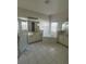 Bright bathroom featuring white tile floors, double sinks, soaking tub and separate shower stall at 3557 Valleyview Dr, Kissimmee, FL 34746