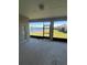 Covered patio with a serene view of the lake and lush greenery at 3557 Valleyview Dr, Kissimmee, FL 34746